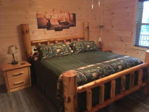 a bedroom with a bed in a log cabin at Little Elk Cabin in Banner Elk