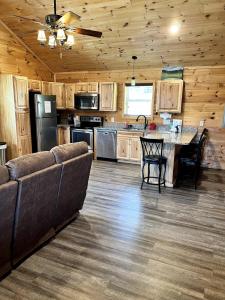 a large kitchen with a couch and a table at Little Elk Cabin in Banner Elk