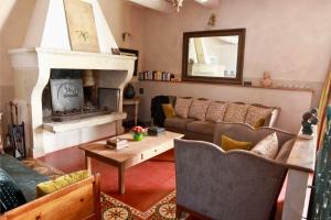 a living room with a couch and a fireplace at Justin de Provence in Orange