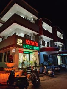 a group of motorcycles parked outside of a building at Kings Executive and Restaurant in Tuljapur