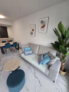 a living room with a couch and a table at Playa Flamenca modern groundfloor apartment with pool access in Orihuela Costa