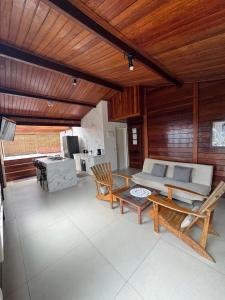 a living room with a couch and a table and chairs at CASA DA MATA - LAVRAS NOVAS in Lavras Novas