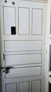 a white door with a knob on it at Tuyu Chhye in Kathmandu