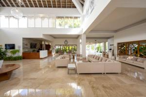 a large living room with couches and a table at Viva Heavens by Wyndham, A Trademark All Inclusive in San Felipe de Puerto Plata