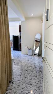 a room with a hallway with curtains and a floor at Tuyu Chhye in Kathmandu