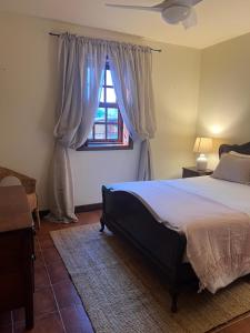 a bedroom with a large bed and a window at Quinta do Pomarinho - Arouca in Arouca +28 photos