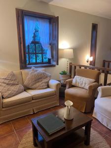 a living room with two couches and a table at Quinta do Pomarinho - Arouca in Arouca