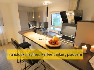 a kitchen with a table with a bowl of fruit on it at Ferienhaus Däschinger in Mastershausen