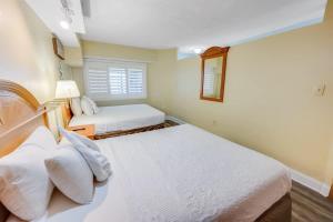 a bedroom with two beds and a window at New Beachfront, Condo Simply Amazing Pools & Views in Myrtle Beach +68 photos