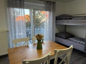 a dining room table with a vase of flowers on it at FeWo Hess in Rust