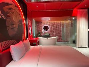 a red bedroom with a bed and a bath tub at Nhật Tân Hotel Vĩnh Ngọc II- Đông Anh in Dong Anh