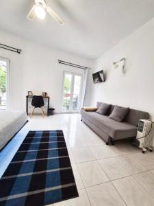 a living room with a couch and a rug at The Central Guesthouse in Faro