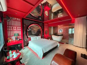 a red bedroom with a bed and a bath tub at Nhật Tân Hotel Vĩnh Ngọc II- Đông Anh in Dong Anh