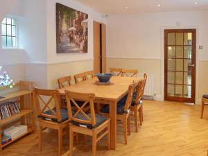 a dining room with a wooden table and chairs at Sandfield The Promenade in Southport +22 photos