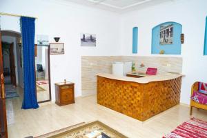 a kitchen with a counter in a room at Aisha Guest House And Restaurant in Al Aqālitah