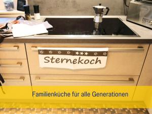 a kitchen counter with a sink with a sign on it at Ferienhaus Däschinger in Mastershausen