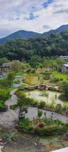 a garden with trees and plants in a field at Shin Mei B&B in Puli
