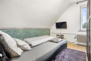 a bedroom with a bed and a flat screen tv at Heide Ferienwohnung West Nr-4 in Schneverdingen