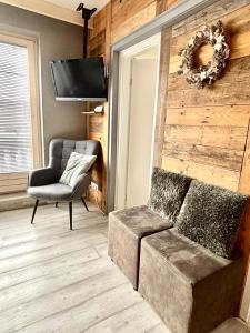 a living room with a couch and a chair at Poppenberg Lodge in Winterberg
