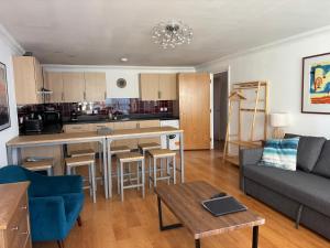 a living room with a couch and a table at Millgrove House Apartments in Eastbourne