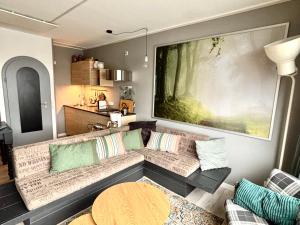 a living room with a couch and a table at Poppenberg Lodge in Winterberg