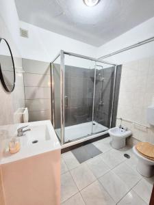 a bathroom with a shower and a toilet and a sink at The Central Guesthouse in Faro +88 photos