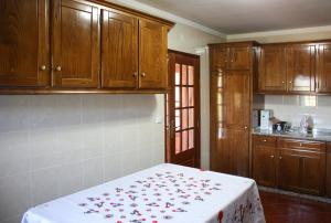 テーラス・デ・ボウロにあるAlojamento Albino Pintoの赤い花のベッド付きのキッチンが備わります。