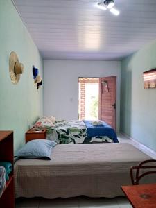 a bedroom with a bed and a window at Aguapé 4 in Barreirinhas