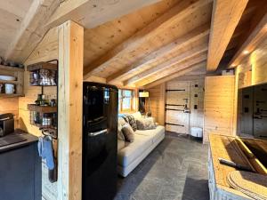 a living room with a white couch in a cabin at Chalet Flond in Obersaxen