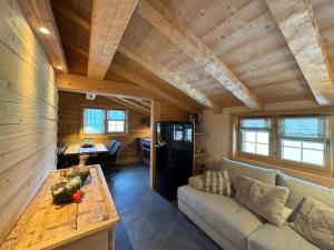 a living room with a couch and a table at Chalet Flond in Obersaxen