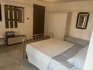 a small bedroom with a bed and a door at La Gisina B&B in Gaglianico