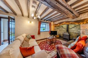 a living room with a couch and a fireplace at 3 Bed in Denbigh oc-waf147 in Gwaynynog