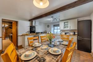 a kitchen and dining room with a table and chairs at 3 Bed in Denbigh oc-waf147 in Gwaynynog
