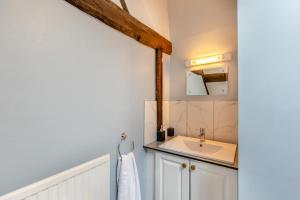 a bathroom with a sink and a mirror at 3 Bed in Denbigh oc-waf147 in Gwaynynog +20 photos