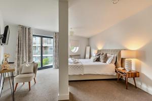 a bedroom with a bed and a table and a chair at 2 Bed in Woolacombe oc-m29811 in Woolacombe +9 photos