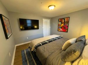 a bedroom with a bed and a flat screen tv at Crossroads at Park Place in Wilmington