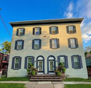 a yellow and white house with black windows at Crossroads at Park Place in Wilmington +1 photo