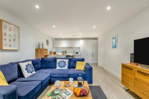 a living room with a blue couch and a tv at 2 Bed in Woolacombe oc-c29617 in Woolacombe