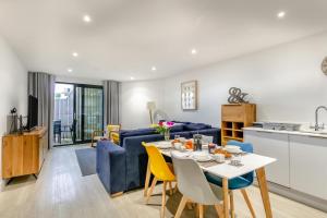 a living room with a blue couch and a table and chairs at 2 Bed in Woolacombe oc-c29617 in Woolacombe