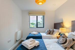 a bedroom with two beds and a window at 2 Bed in Woolacombe oc-c29617 in Woolacombe +21 photos