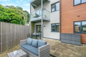 a patio with a chair and a table in front of a building at 2 Bed in Woolacombe oc-c29617 in Woolacombe