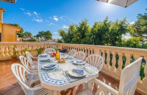 a white table and chairs on a balcony at Ideal Property Mallorca - Can Besso in Alcanada