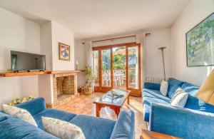 a living room with blue couches and a fireplace at Ideal Property Mallorca - Can Besso in Alcanada