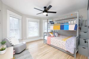a bedroom with a bed and a ceiling fan at Walk to Highland Square, Sleeps 8 in Akron +45 photos