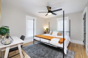a bedroom with a bed and a ceiling fan at Walk to Highland Square, Sleeps 8 in Akron