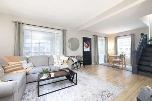 a living room with a couch and a table at Walk to Highland Square, Sleeps 8 in Akron
