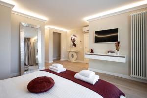 a bedroom with a large bed with two white towels at NEW Casa Florentia in Ambrogiana +17 photos