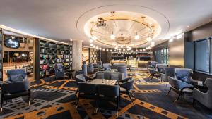 a restaurant with a large chandelier and tables and chairs at Crowne Plaza Shanghai by IHG in Shanghai