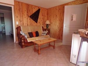 a living room with a couch and a coffee table at La Grange in Dieulivol