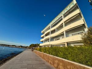 a large apartment building next to the water at Villa Luciana in Grado